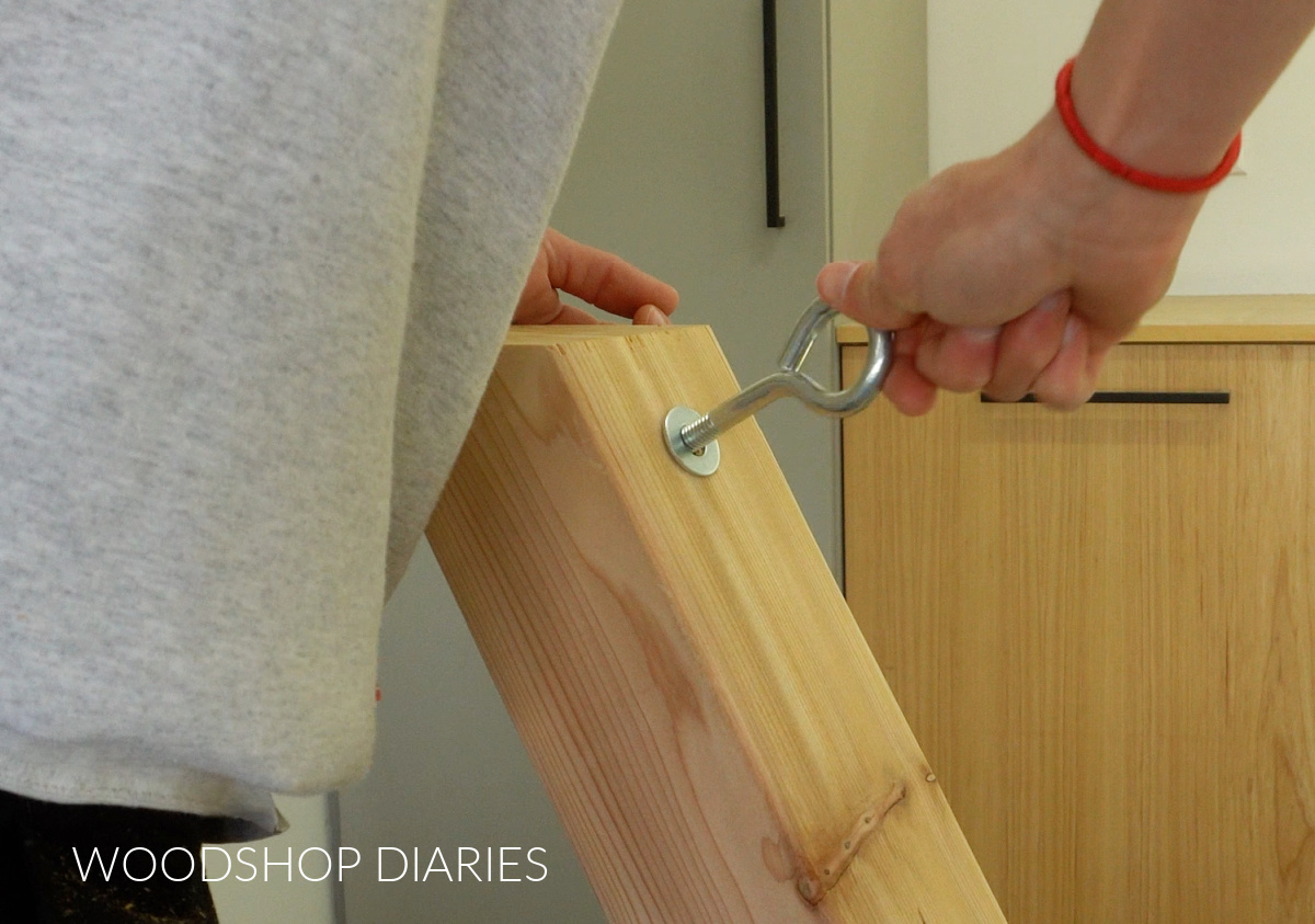 Shara Woodshop Diaries installing eye bolt into hammock stand post with washer