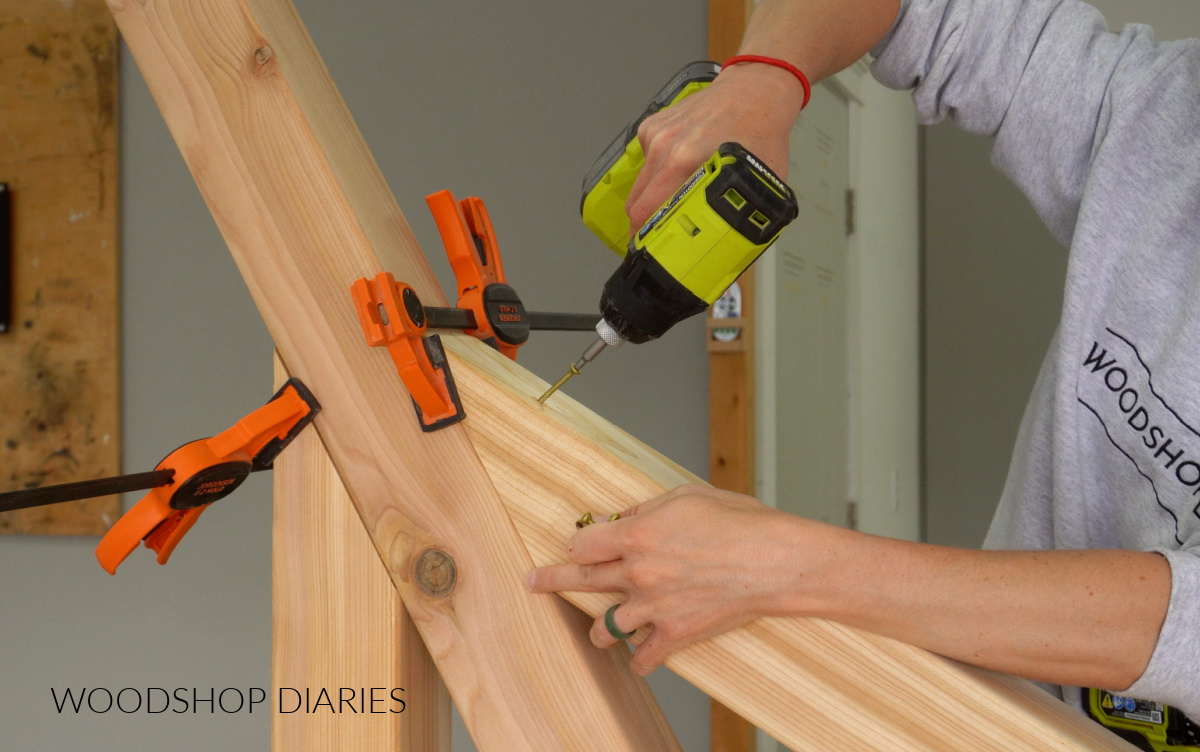Close up of Shara Woodshop Diaries driving screw to secure supports to hammock stand post