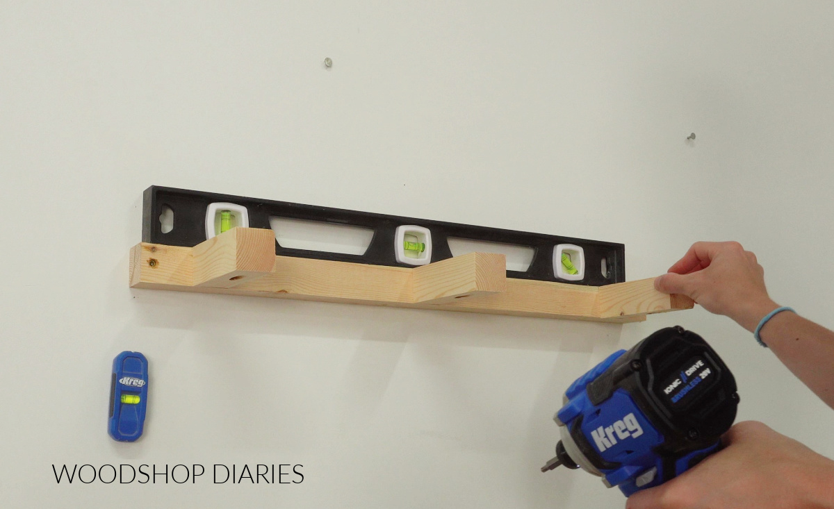 E shaped frame installed on wall for floating shelf