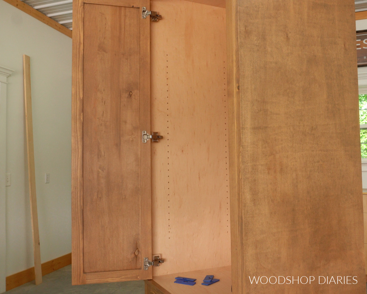 Tall cabinet door installed with concealed hinges to cabinet box