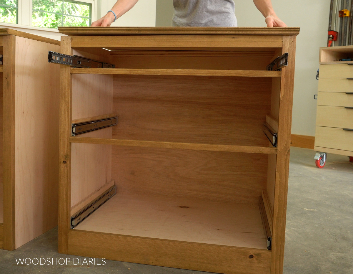 3 drawer DIY cabinet box with slides installed. Shara Woodshop Diaries placing top panel over the top