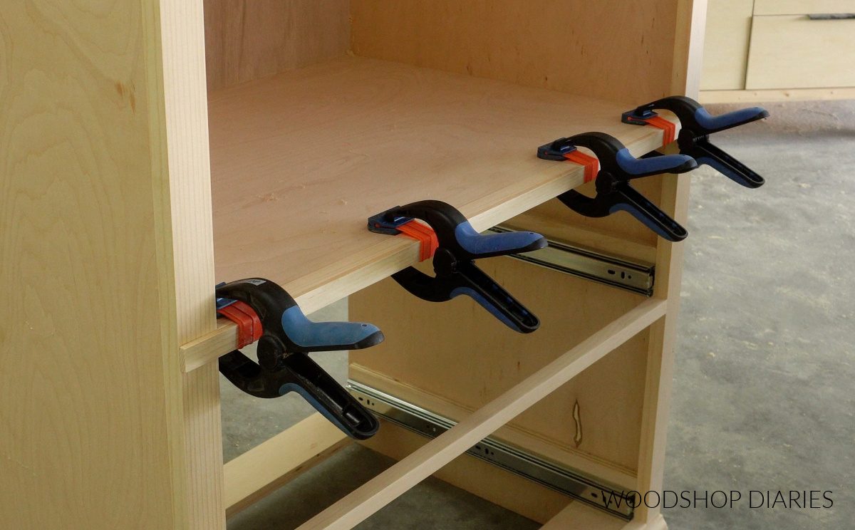Lattice trim clamped onto front of cabinet