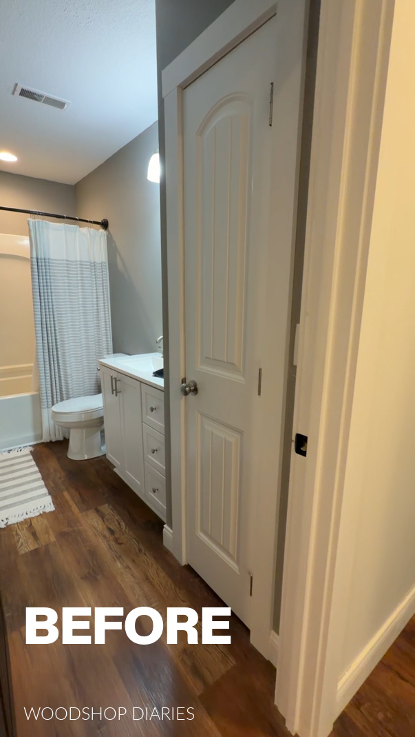 Bathroom closet--plain white door with white trim just inside bathroom entrance