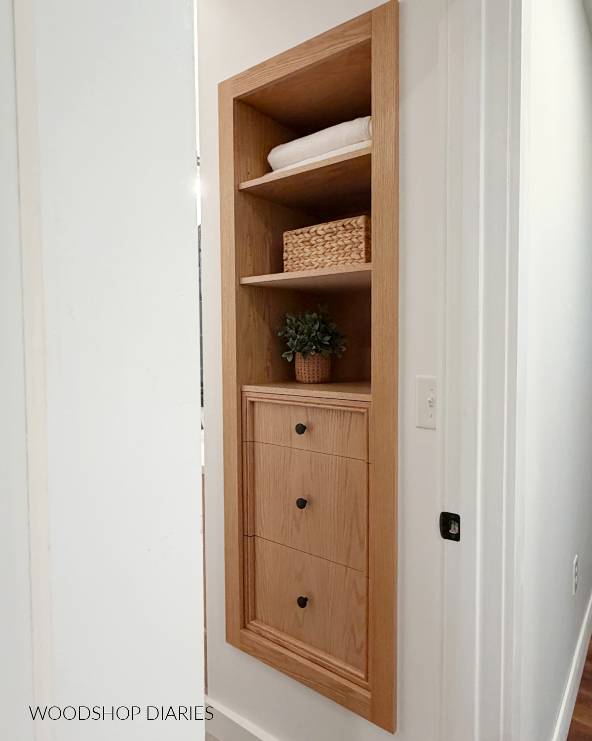 Built in cabinet in place of closet door in bathroom. DIY cabinet made of red oak plywood