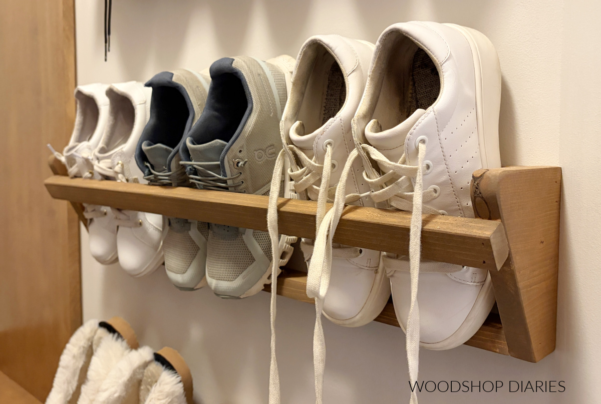 DIY wall mounted shoe rack with three pair of shoes inside