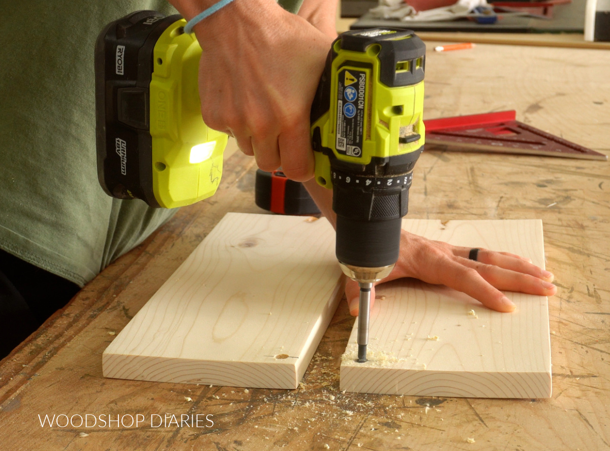 Shara Woodshop Diaries drilling holes for over stove shelf railing on side pieces