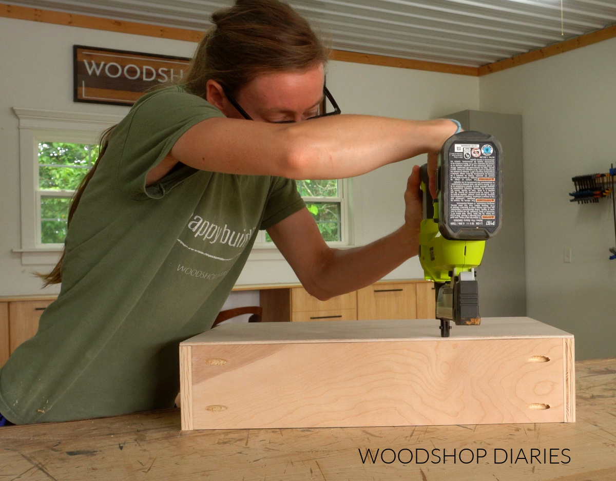 Shara Woodshop Diaries stapling plywood bottom onto drawer boxes