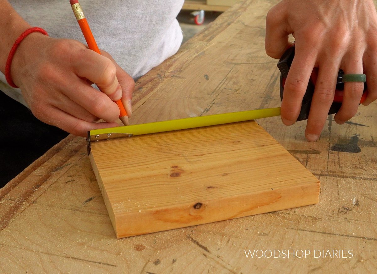 Shara Woodshop Diaries marking corners on scrap 1x6 on workbench