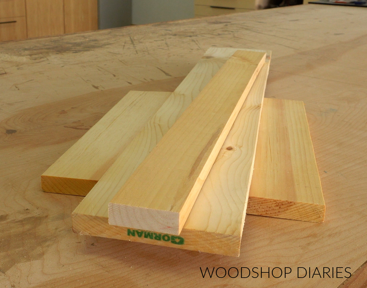 Scrap lumber on workbench: 1x12, 1x6, 1x3 boards