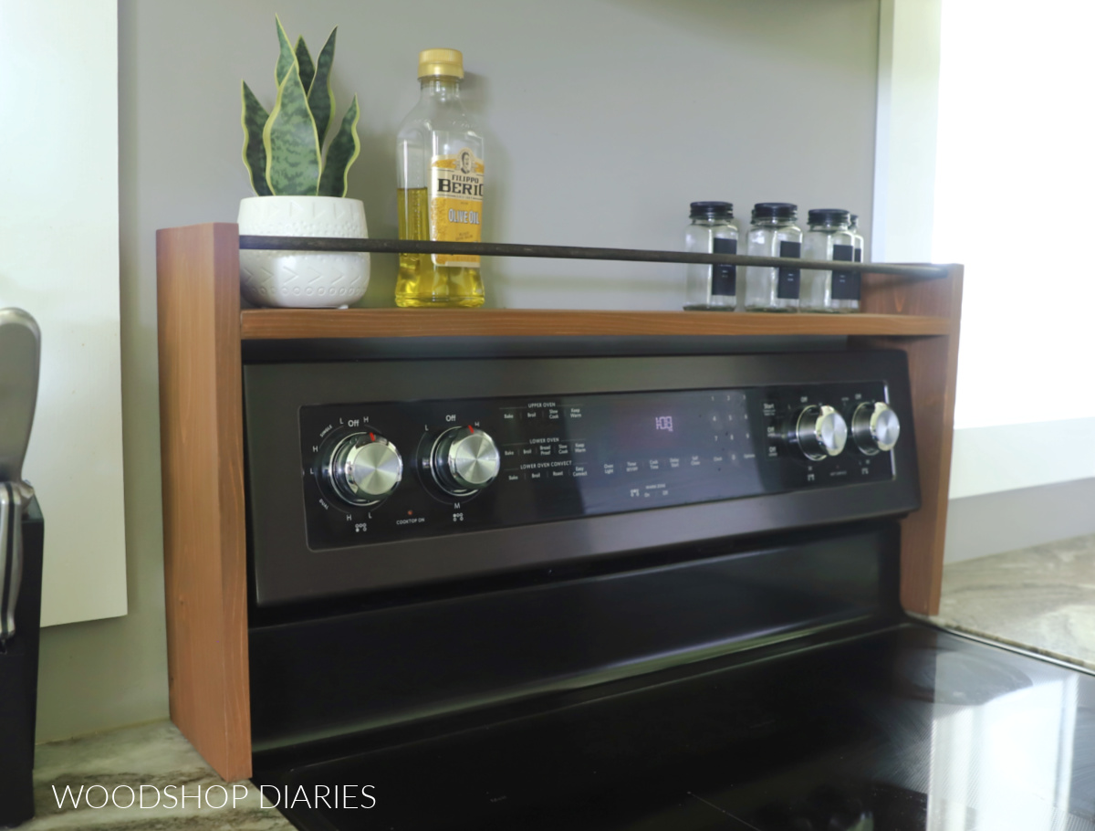DIY wooden over the stove shelf with rail resting on countertop