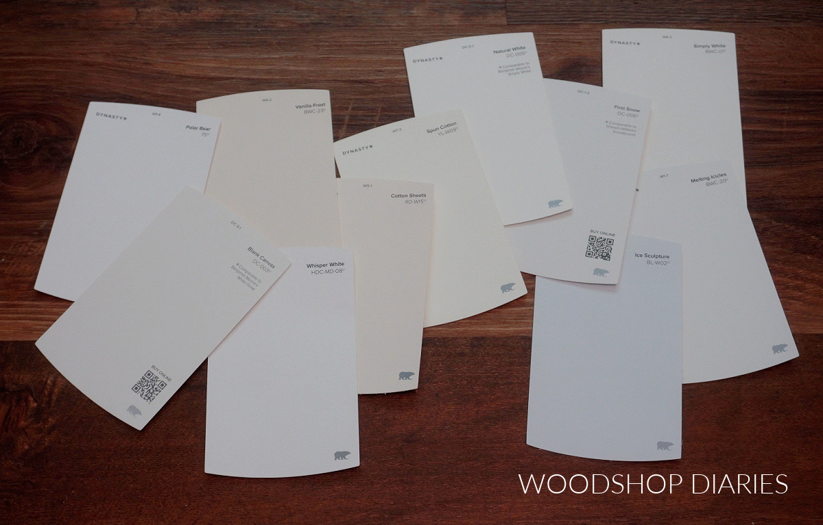 BEHR white paint chips laid out on wood floor