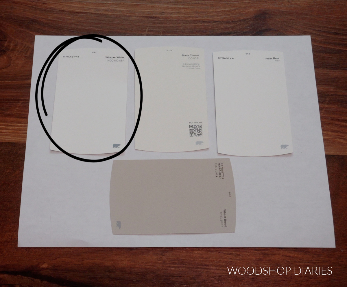 BEHR Whisper White paint chip with BEHR Wheat Bread paint chip on white paper