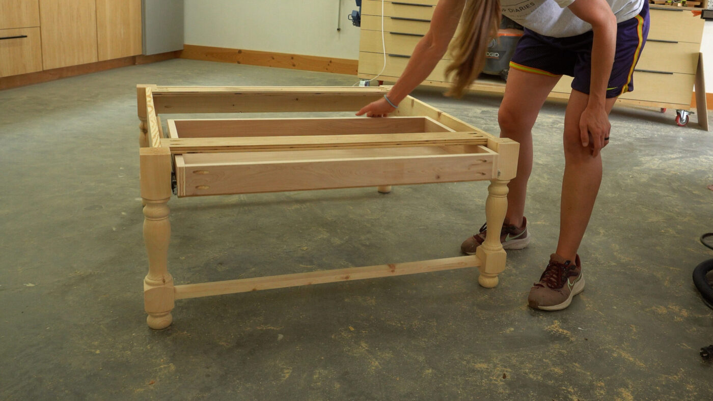 Shara Woodshop Diaries installing drawer box into coffee table base in workshop