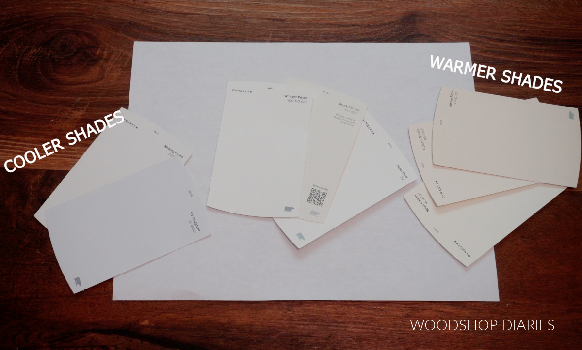 BEHR white paint color chips laid on white paper to show their undertones