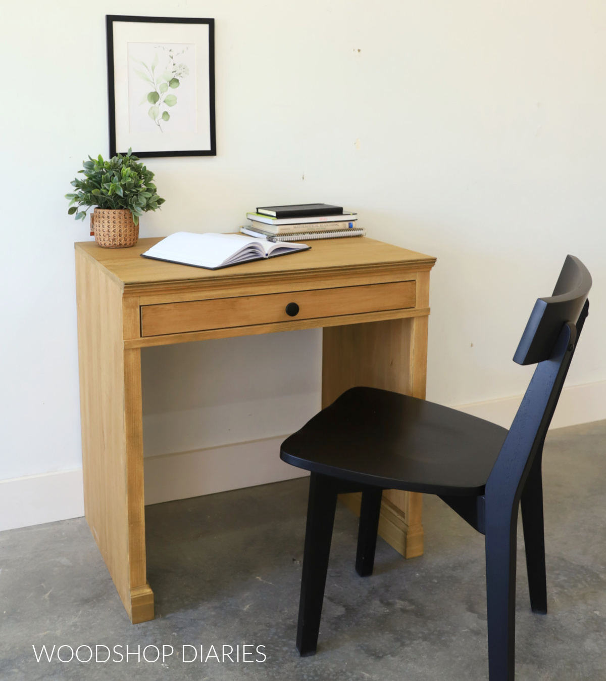 DIY writing desk with shallow drawer and black chair