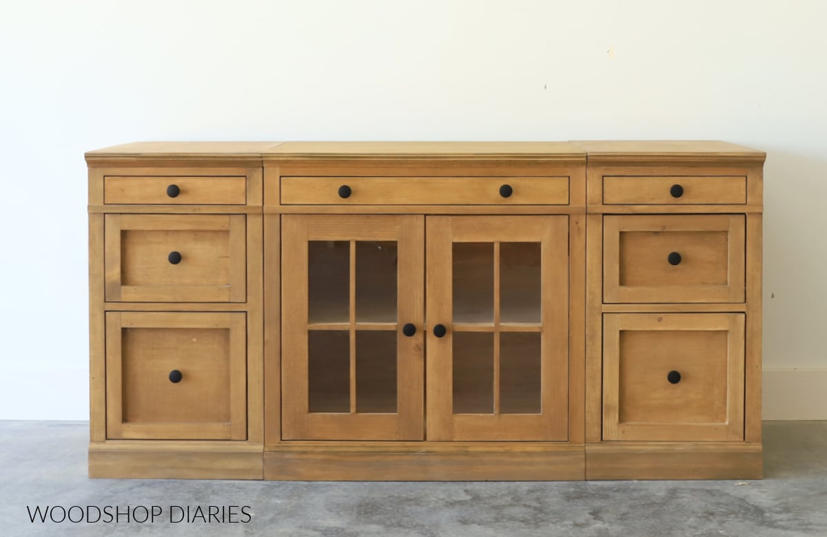 DIY modular furniture system assembled together with wide glass door cabinet in center and two narrow drawer cabinets on each side to make a media console