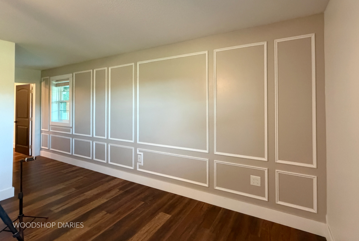 Picture frame molding installed on bedroom wall flowing into hallway
